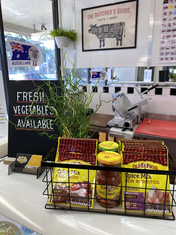 Inside the shop: the Butcher's Guide beef chart, an Aussie Lamb sign and the fresh vegetables board