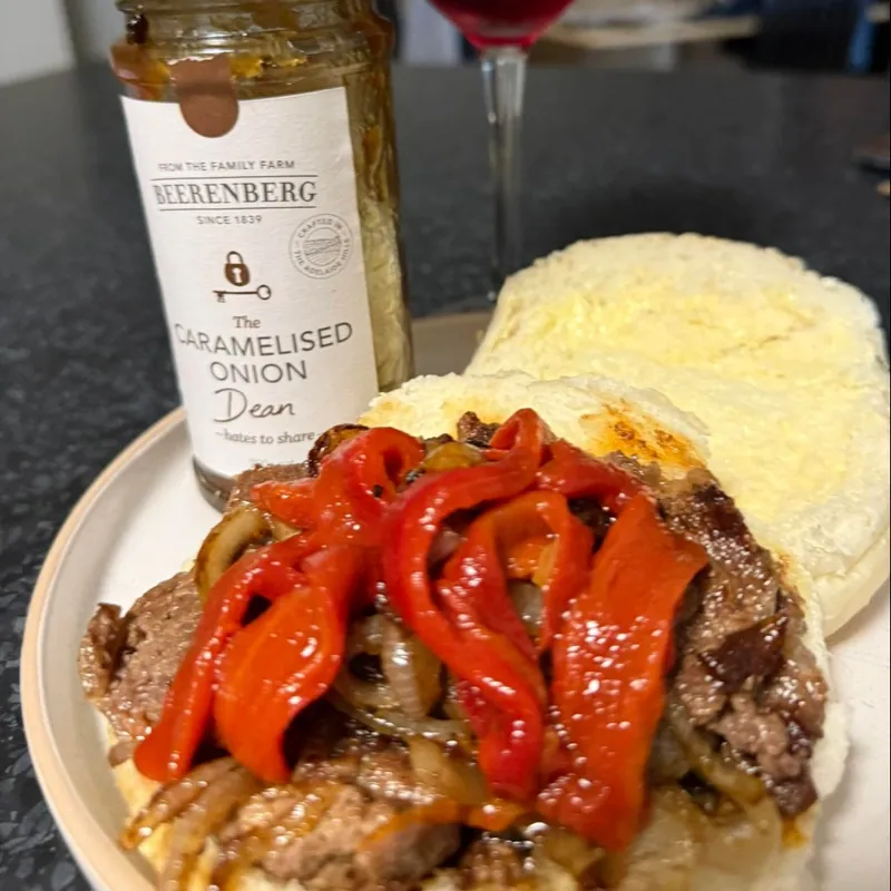 A steak sandwich with roasted capsicum and caramelised onions